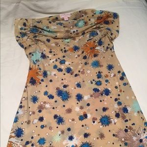 Tan sleeveless blouse with multi color accents.